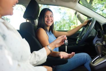 A girl behind the wheel with an instructor